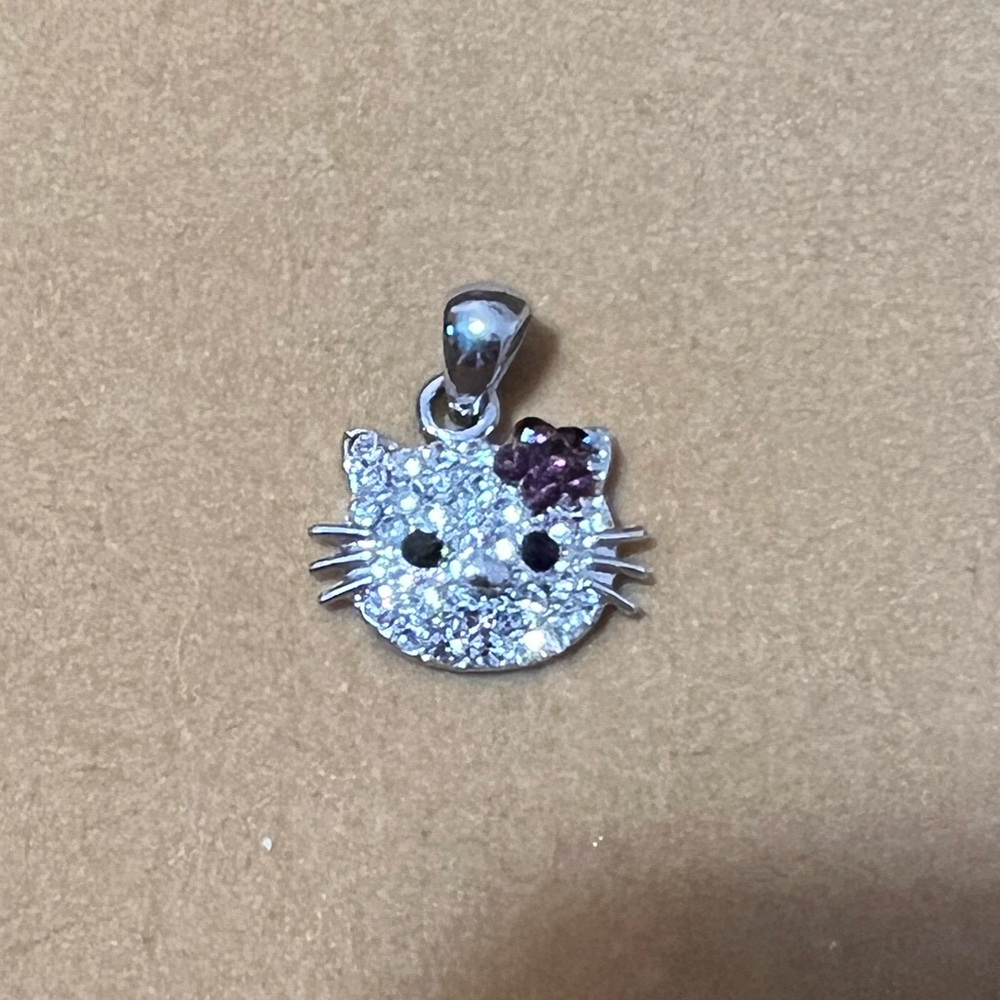 Silver hello Kitty pendant with purple flower and black eyes